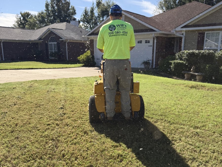 Will on the mower cutting a front lawn